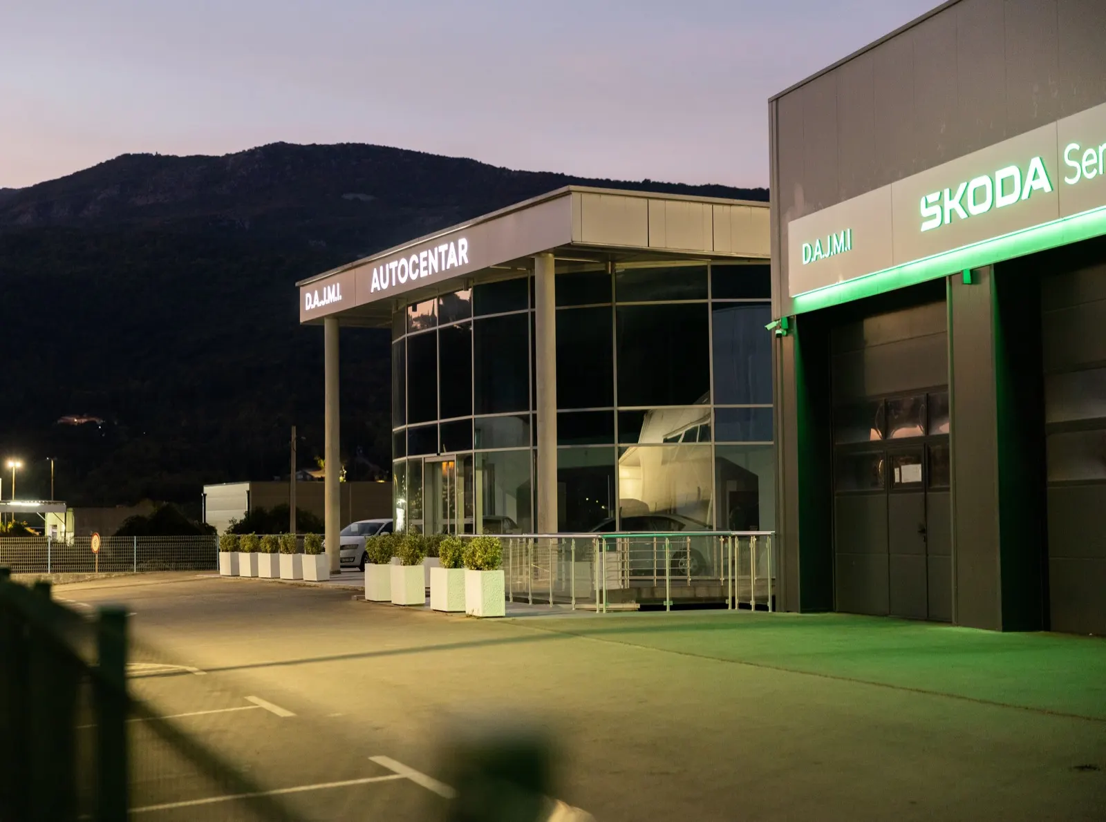 D.A.J.M.I. Autocentar and Škoda service at dusk